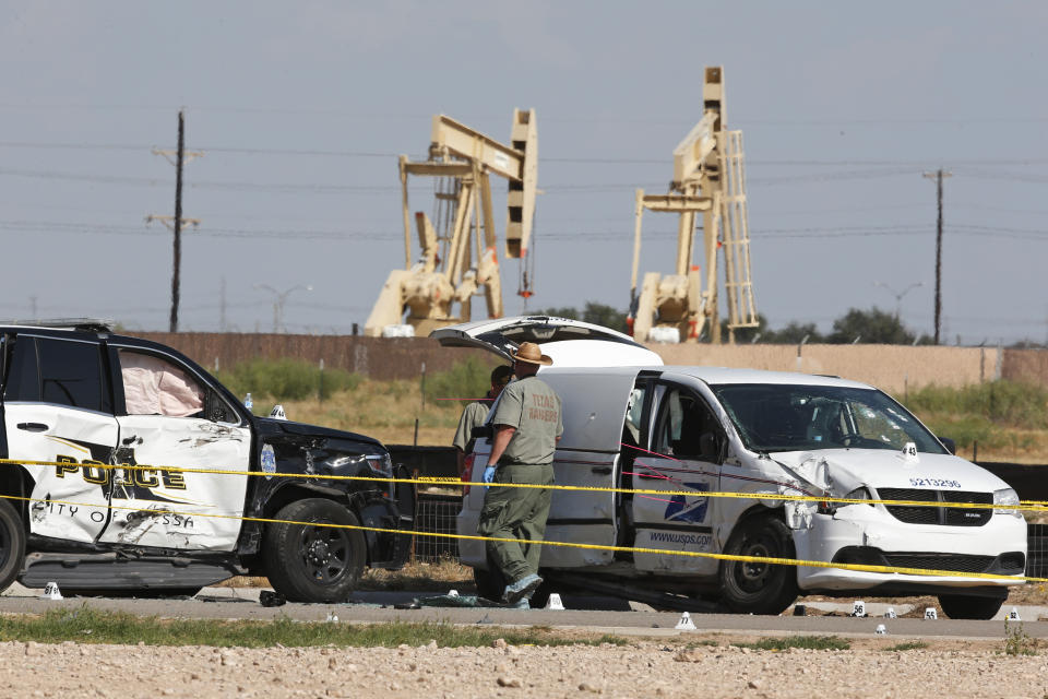 Law enforcement officials process the crime scene Sunday, Sept. 1, 2019, in Odessa, Texas, from Saturday's shooting which ended with the alleged shooter being shot dead by police in a stolen mail van, right. (AP Photo/Sue Ogrocki)