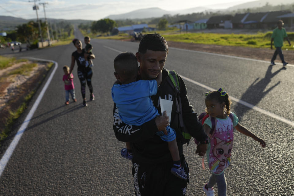 Venezuelan Miguel Gonzalez and his family walk to transportation that will take them to the Brazilian border, in Santa Elena, Venezuela, Wednesday, April 5, 2023. Behind is his partner Maryelis Rodriguez as they hold hands and carry their four young children. Gonzalez sold his family’s fridge, fan, bed, kitchen and some other furniture, stuffed clothes and several diapers in duffel bags and backpacks, and began their migration journey from their community of San Felix with $500. (AP Photo/Matias Delacroix)