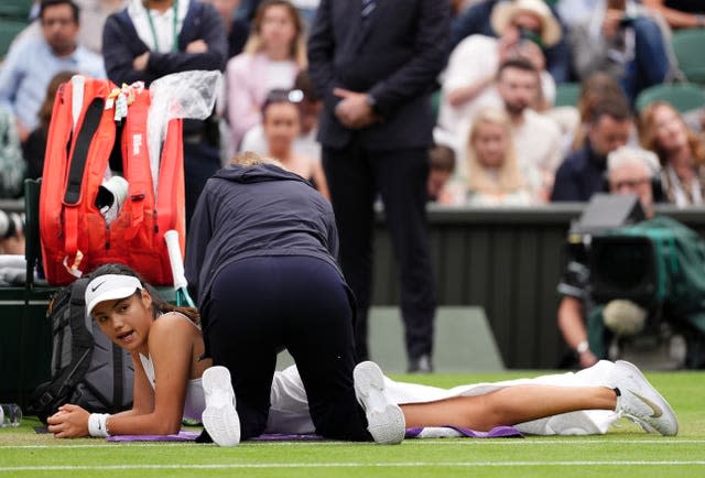 Emma Raducanu receives treatment on Centre Court during her fourth-round loss to Lulu Sun