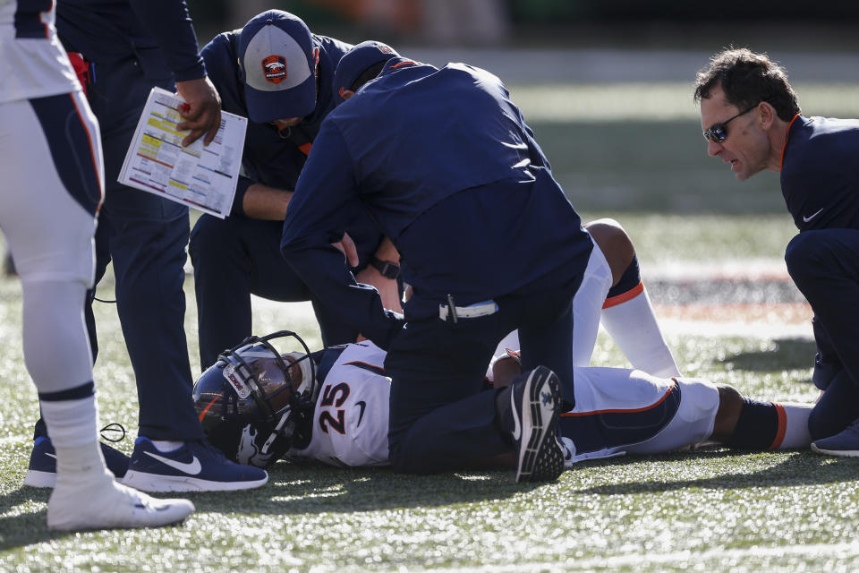 Denver Broncos cornerback Chris Harris (25) lies on the field with an apparent injury in the first half of an NFL football game against the Cincinnati Bengals, Sunday, Dec. 2, 2018, in Cincinnati. (AP Photo/Gary Landers)