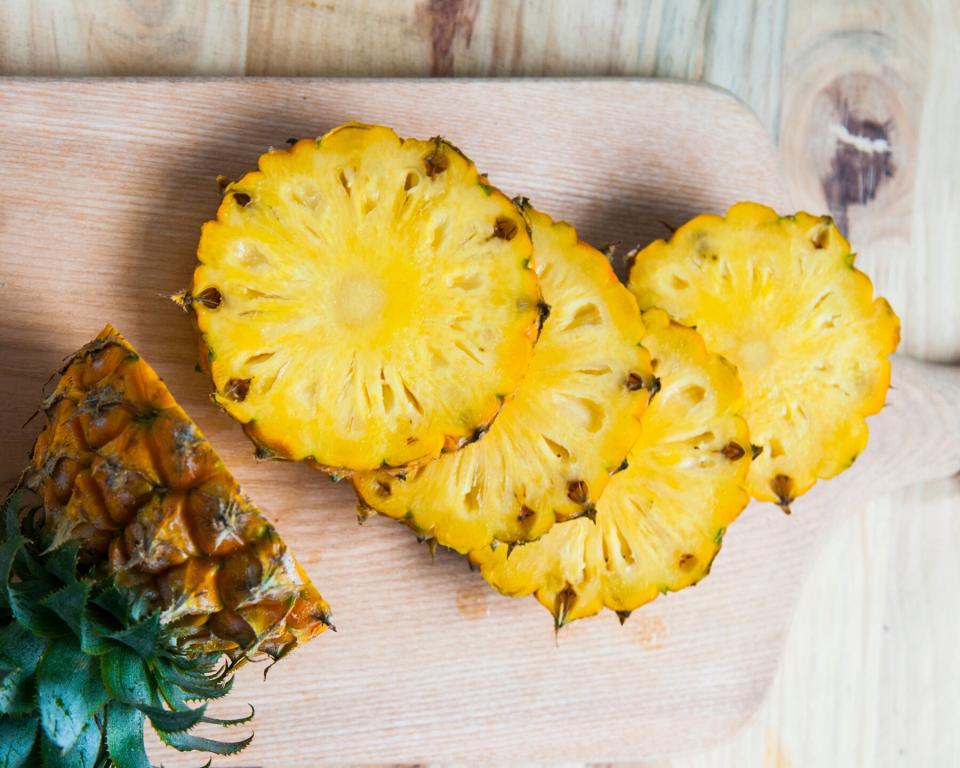 High-Fiber fruit: sliced pineapple on a wooden cutting board