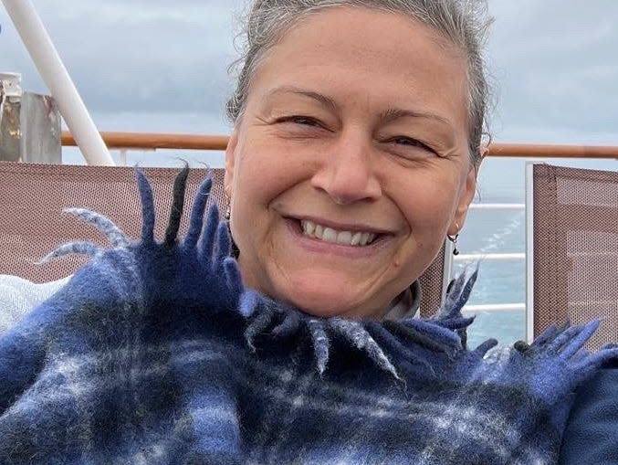 rebecca wrapped in a blue tartan blanket on an alaskan cruise ship