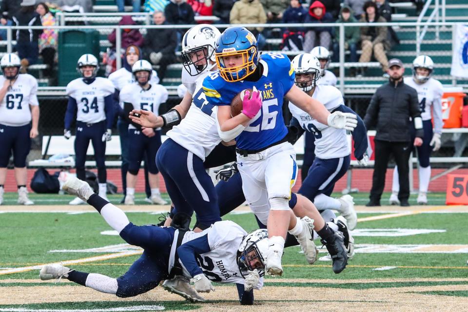 Aidan McHugh from Maine-Endwell escapes the grasp of the Homer defense during the state quarterfinals.