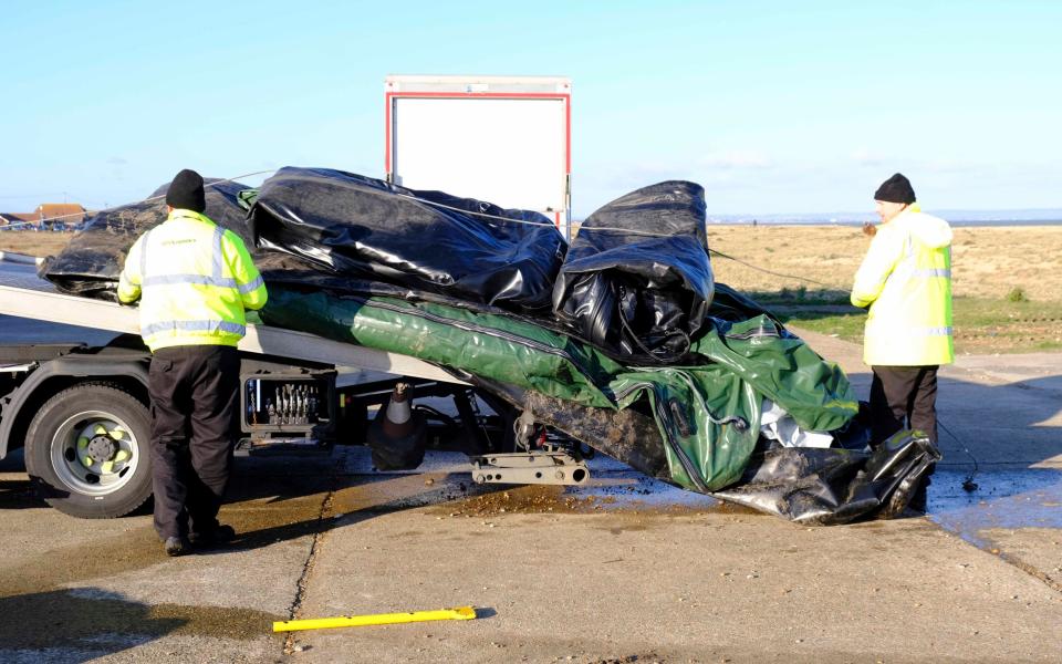 Workmen remove deflated dinghies - Steve Finn/Steve Finn Photography