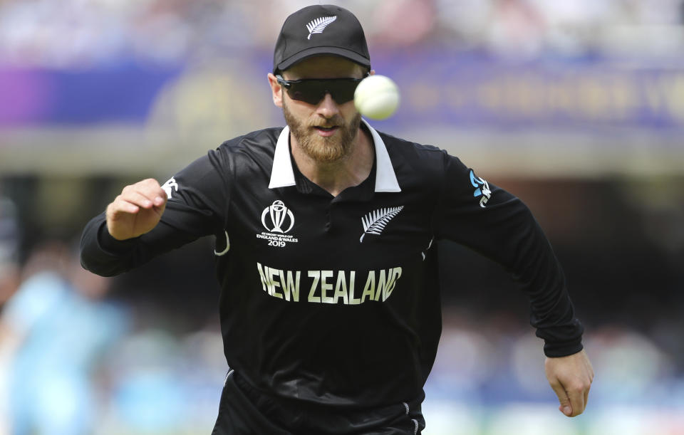 New Zealand's captain Kane Williamson chases the ball after a shot played by England's captain Eoin Morgan during the Cricket World Cup final match between England and New Zealand at Lord's cricket ground in London, England, Sunday, July 14, 2019. (AP Photo/Aijaz Rahi)