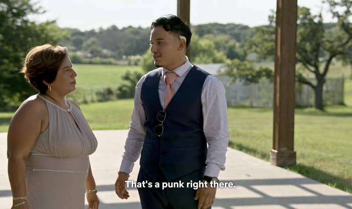 Erendira and Steve talking to each other outside Nancy's wedding with the caption "That's a punk right there"
