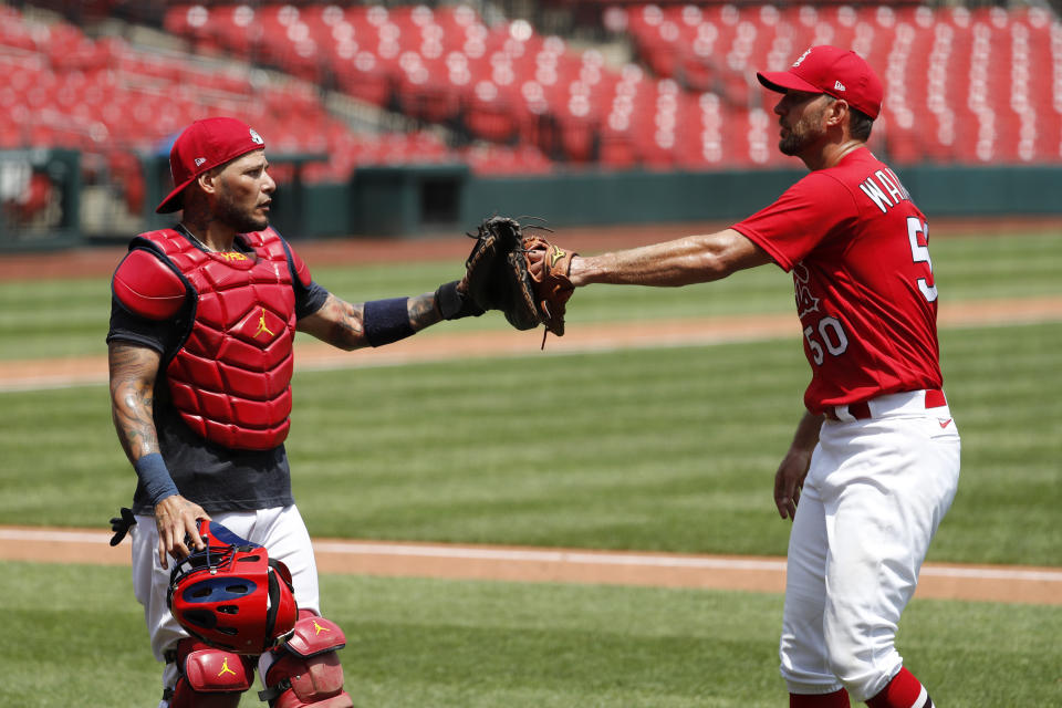 St. Louis Cardinals pitcher Adam Wainwright, right, is congratulated by catcher Yadier Molina after throwing a simulated inning during baseball practice at Busch Stadium Sunday, July 5, 2020, in St. Louis. (AP Photo/Jeff Roberson)