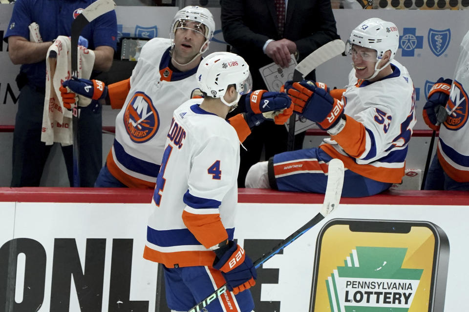 New York Islanders' Samuel Bolduc (4) returns to the bench after scoring against the Pittsburgh Penguins during the third period of an NHL hockey game Sunday, Dec. 31, 2023, in Pittsburgh. (AP Photo/Matt Freed)
