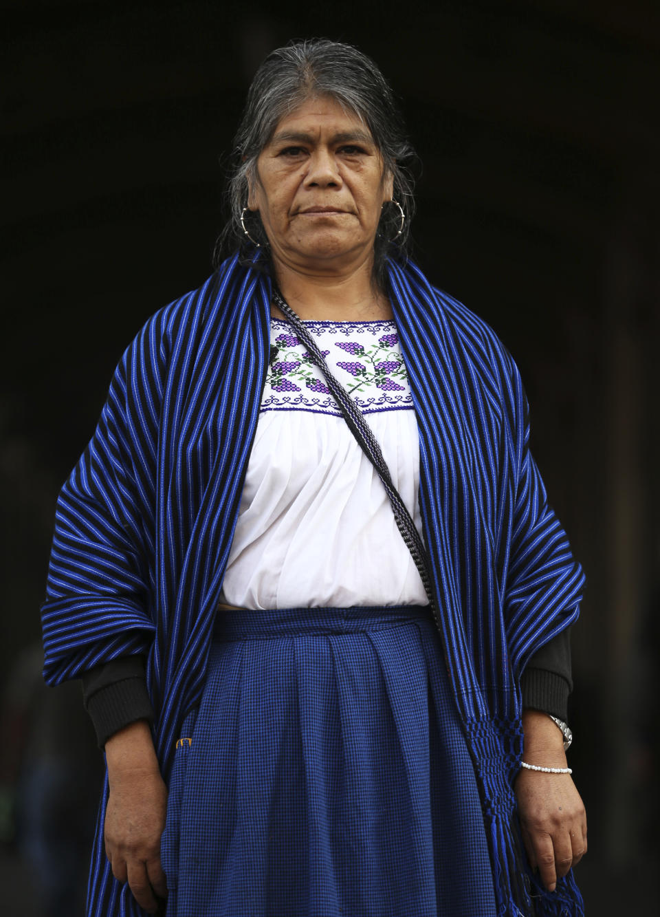 Maria Sara Guzman poses for a photo during an interview in the Zocalo in Mexico City, Friday, Nov. 29, 2019. An artisan from the Purepecha indigenous community of the state of Michoacan, Guzman says she already feels a bit disillusioned with Lopez Obrador. (AP Photo/Marco Ugarte)