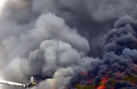 An Egyptian firefighter tries to extinguish a fire in Cairo International Convention Centre (CICC) in Cairo's Nasr City district March 4, 2015. REUTERS/Amr Abdallah Dalsh