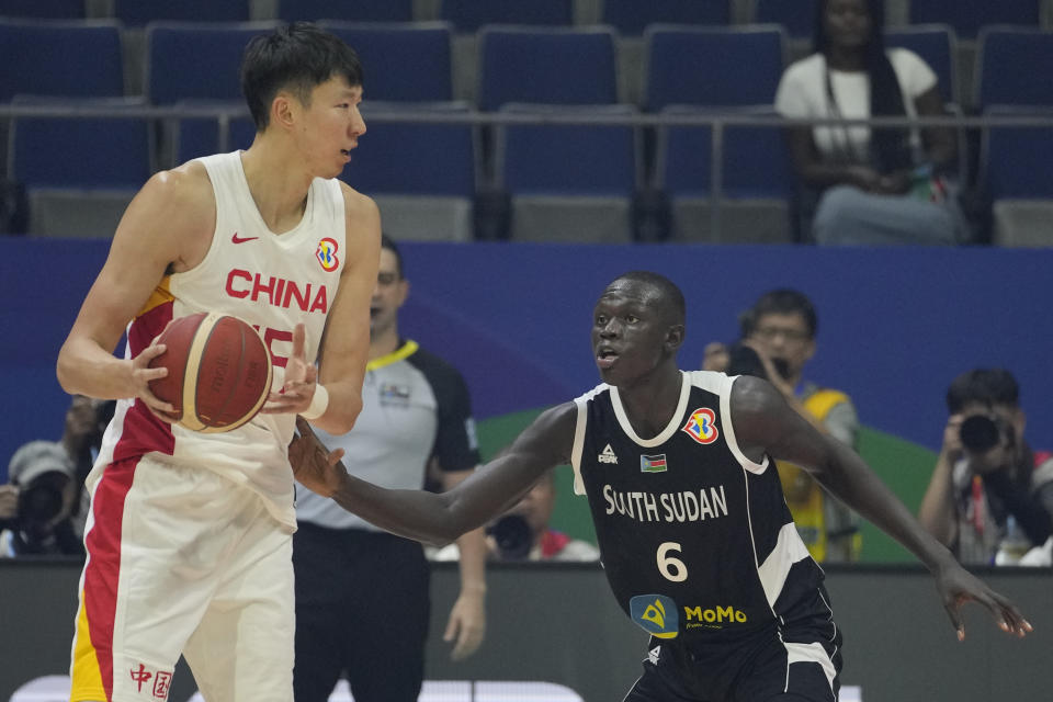 South Sudan center Khaman Madit Maluach (6) guards China center Zhou Qi (15) during their Basketball World Cup group B match at the Araneta Coliseum in Manila, Philippines Monday, Aug. 28, 2023. (AP Photo/Aaron Favila)