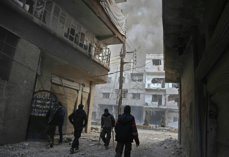 Syrians in the rebel-held enclave of Eastern Ghouta use the rare lulls in bombardment to emerge from their underground dwellings and stock up on food and wood