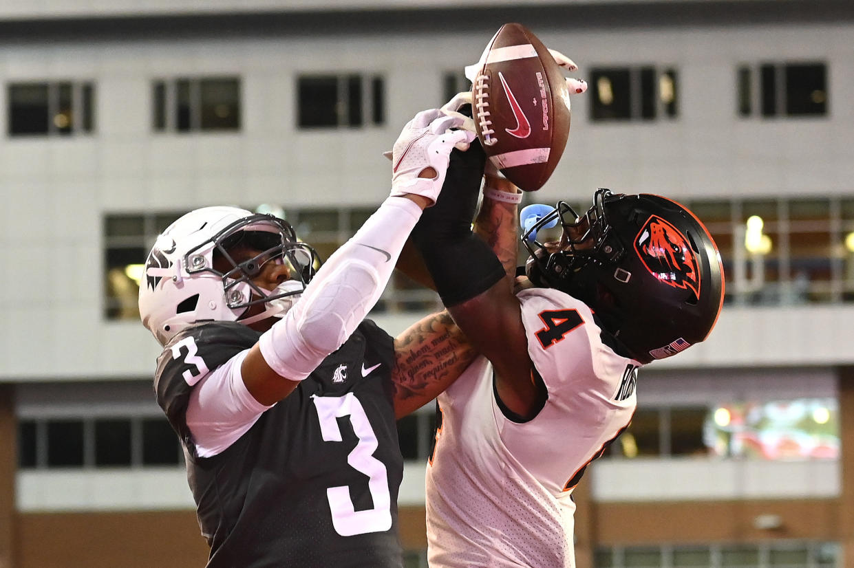 Sep 23, 2023; Pullman, Washington, USA; Oregon State Beavers defensive back Jaden Robinson (4) breaks up a pass against Washington State Cougars wide receiver Josh Kelly (3) in the second half at Gesa Field at Martin Stadium. Mandatory Credit: James Snook-USA TODAY Sports