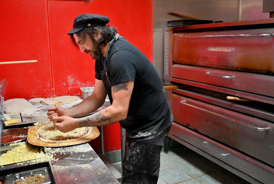 I Love Frankie’s owner and pizza chef Frank Abbatecola prepares a pizza.