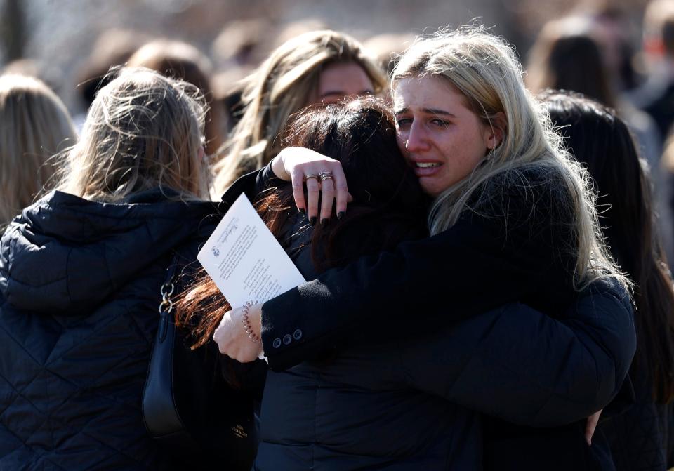 Friends and mourners hug after the casket of Brian Fraser was brought out of St. Paul on the Lake Catholic Church in Grosse Pointe Farms on Saturday, Feb. 18, 2023.Fraser was one of three Michigan State University students shot and killed by a gunman on campus on Monday, Feb. 13, 2023.