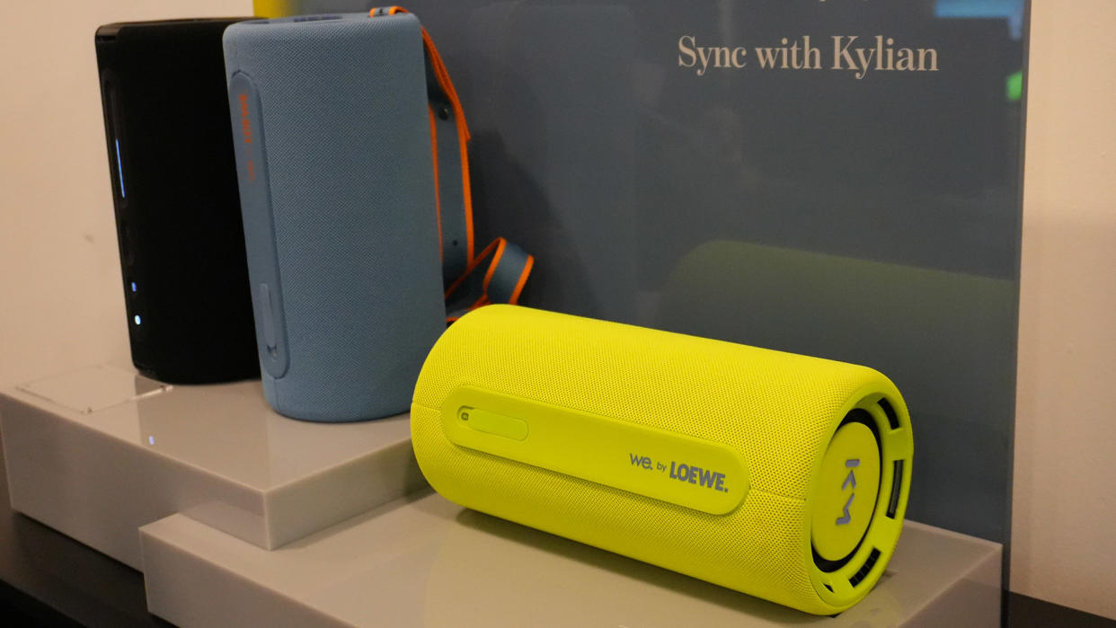  Three Bluetooth speakers sit side by side on a table. 