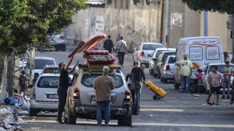 Residents of Gaza City load a car with their belongings as they begin to evacuate on October 14.  - Mohammed Saber/EPA-EFE/Shutterstock
