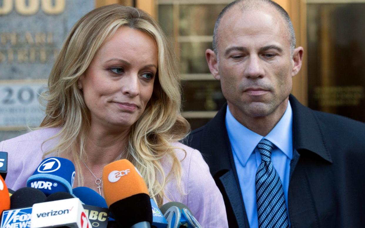 Stormy Daniels with her former lawyer Michael Avenatti speaking outside a court in New York - AP