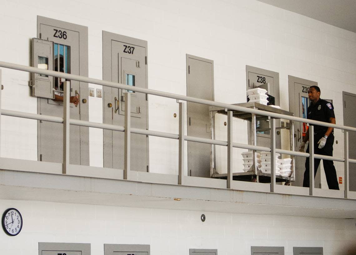 In this file photo from 2013, a correctional officer gives meals to people incarcerated at the Alvin S. Glenn Detention Center, a Richland County jail located just outside of Columbia city limits. Since 2009, at least 18 people have died in the custody of the jail, according to data compiled by The Island Packet.