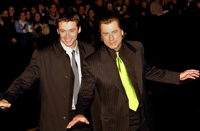 <p>Liam Nicholls/Getty</p> Hugh Jackman and John Travolta in 2001