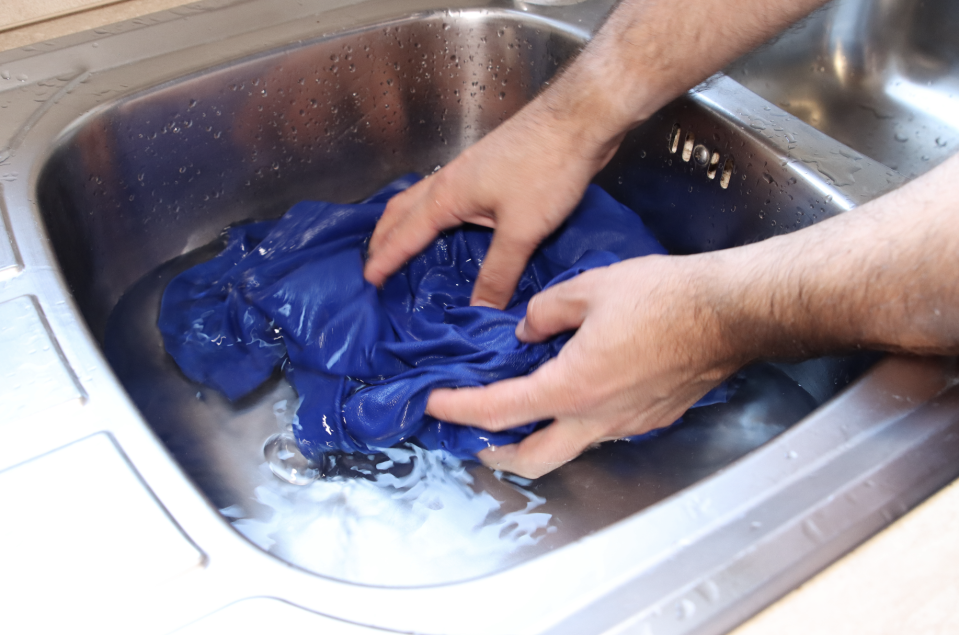 rinsing a shirt in a sink