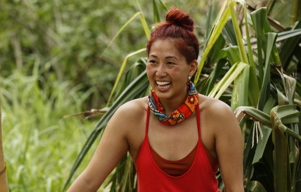 Mari Takahashi smiles while building a shelter