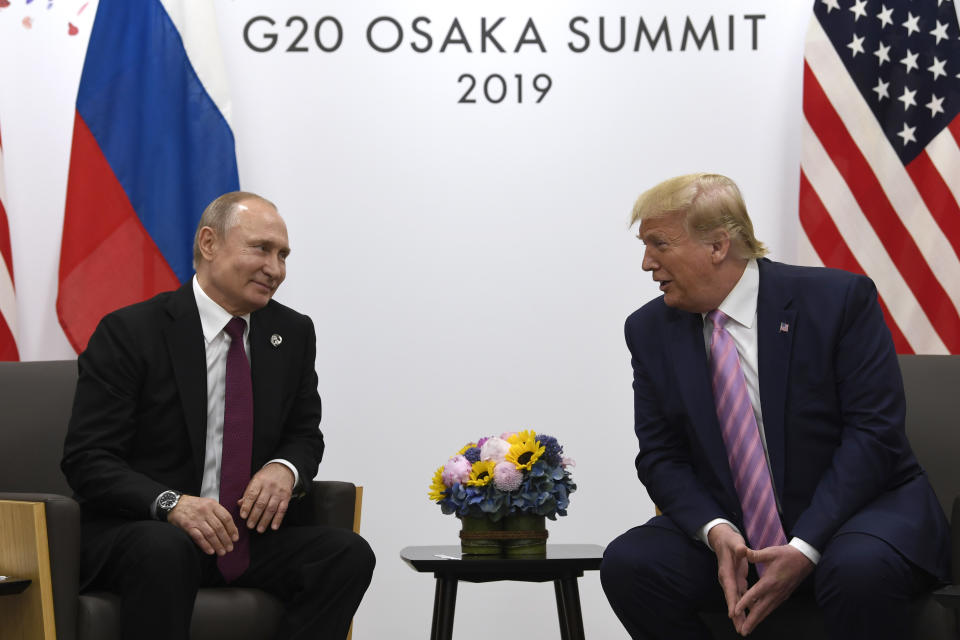 FILE - In this June 28, 2019, file photo, President Donald Trump, right, meets with Russian President Vladimir Putin during a bilateral meeting on the sidelines of the G-20 summit in Osaka, Japan. An odd new front in the U.S.-Russian rivalry has emerged as a Russian military cargo plane bearing a load of urgently needed medical supplies landed in New York’s JFK airport. (AP Photo/Susan Walsh, File)