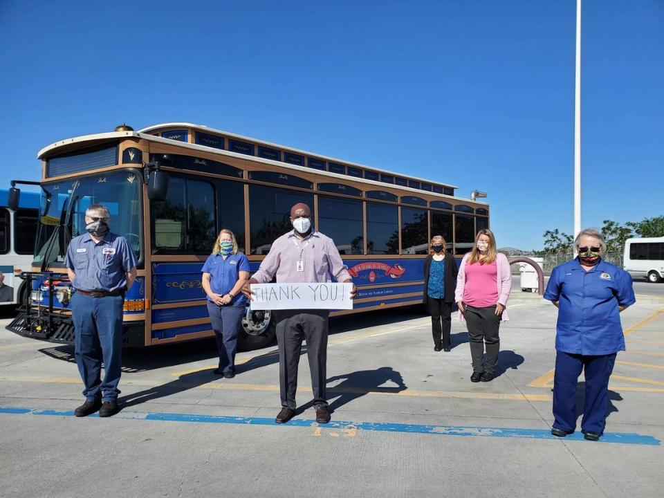 Ayodeji Arojo holds a thank you sign in May 2020 four months after he was hired by Ben Franklin Transit, thanking the community for its support during the early days of the COVID pandemic.