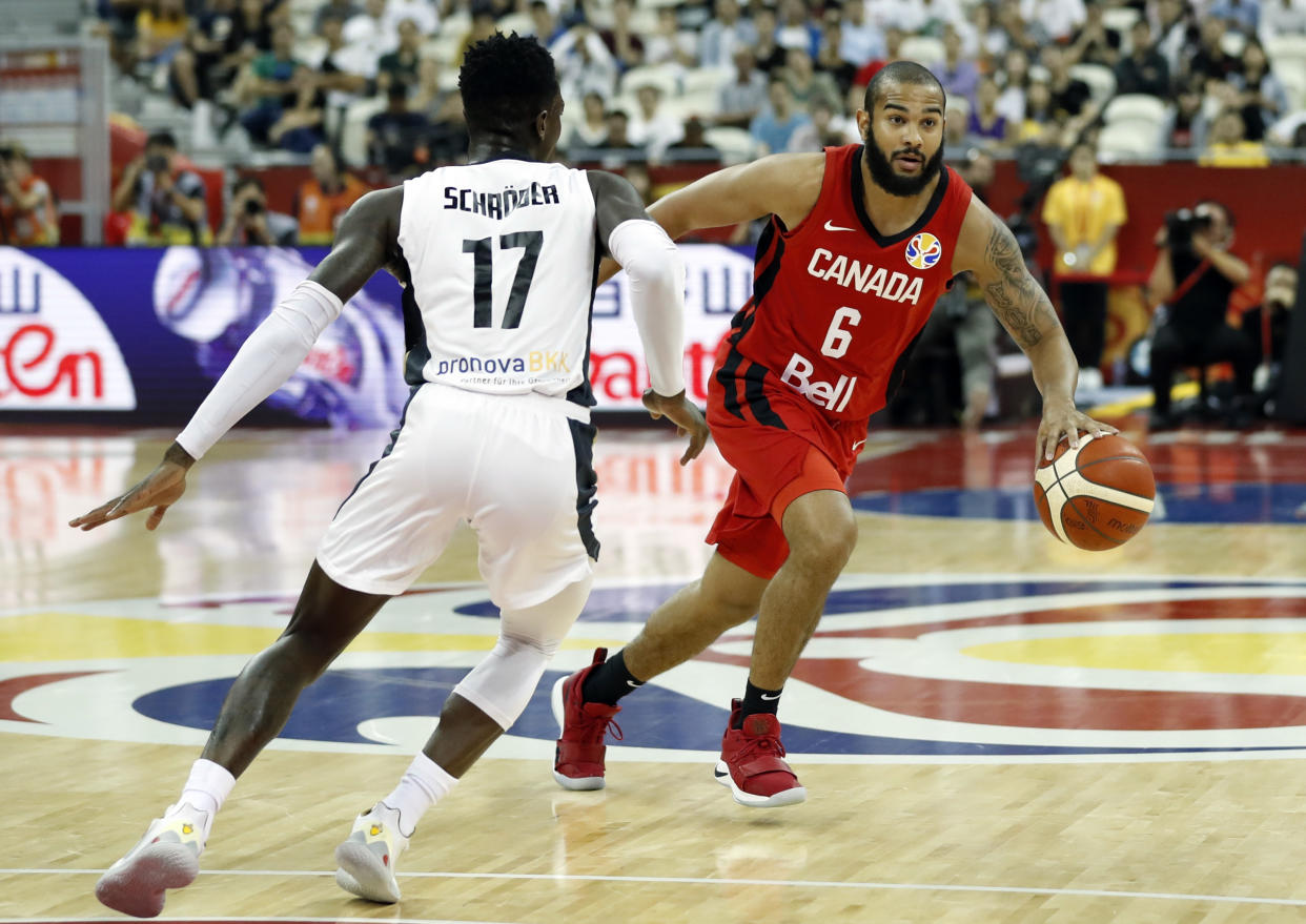 Basketball - FIBA World Cup - Classification Round 17-32 - Group P - Germany v Canada - Shanghai Oriental Sports Center, Shanghai, China - September 9, 2019 Germany's Dennis Schroder in action with Canada's Cory Joseph REUTERS/Aly Song