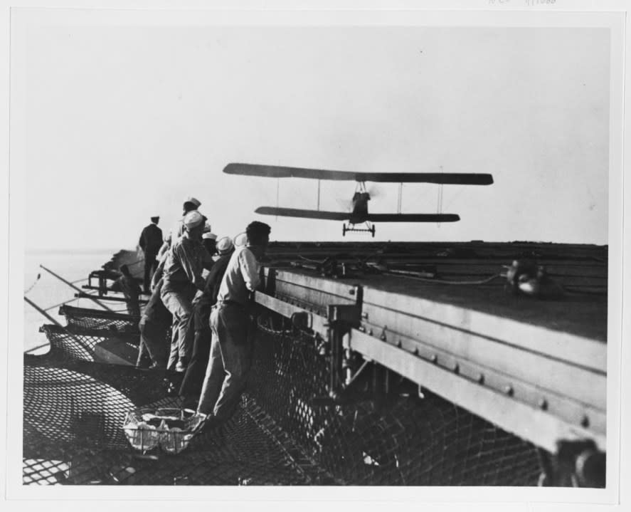 Aeromarine 39-B airplane approaching the flight deck of USS Langley (CV-1) during landing practice, 19 October 1922.