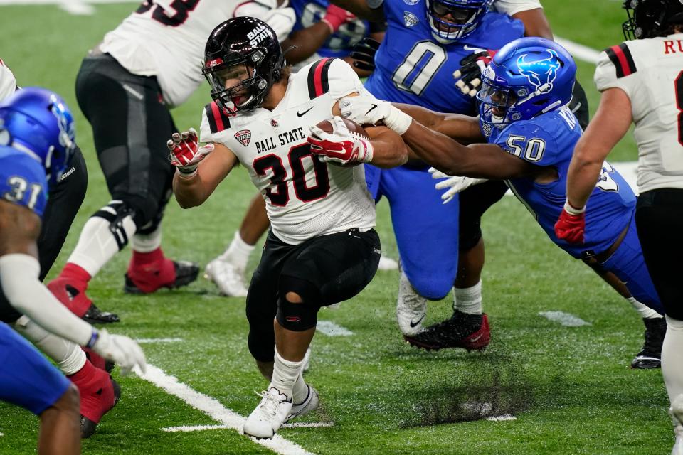 Ball State running back Tye Evans (30) rushes during the second half of the Mid-American Conference championship NCAA college football game against Buffalo, Friday, Dec. 18, 2020 in Detroit. (AP Photo/Carlos Osorio)