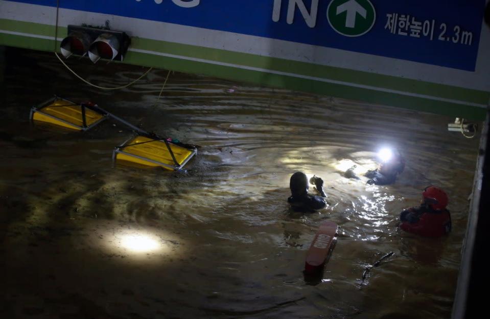 Rescue workers search for survivors (Kim Hee-Chul/EPA)
