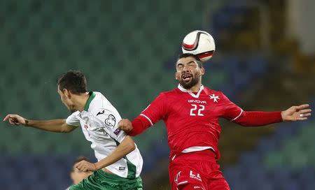 Bulgaria's Georgi Milanov (L) jumps for the ball with Malta's Zach Muscat during their Euro 2016 Group H qualification soccer match at Vassil Levski stadium in Sofia November 16, 2014. REUTERS/Stoyan Nenov