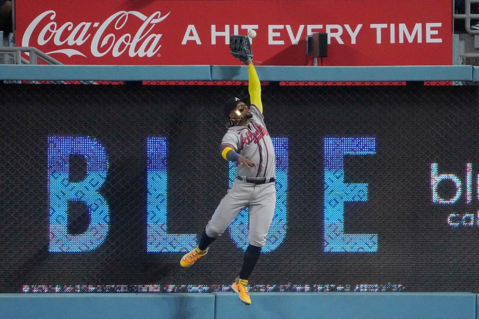 Atlanta Braves right fielder Ronald Acuna Jr. can't catch a ball hit for a three-run home run by Los Angeles Dodgers' Mookie Betts during the fifth inning of a baseball game Thursday, Aug. 31, 2023, in Los Angeles. (AP Photo/Mark J. Terrill)