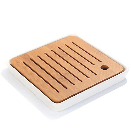 <p><strong>Hoobar</strong></p><p>amazon.com</p><p><strong>$14.99</strong></p><p>Tea party hosting calls for a durable serving tray that'll make your friends say, "Oh, cute!" This modern-looking bamboo option gives you a designated space to rest your cup and has slits over a tray to catch accidental spills. Once tea time is over, just remove the lid and wipe clean. </p>