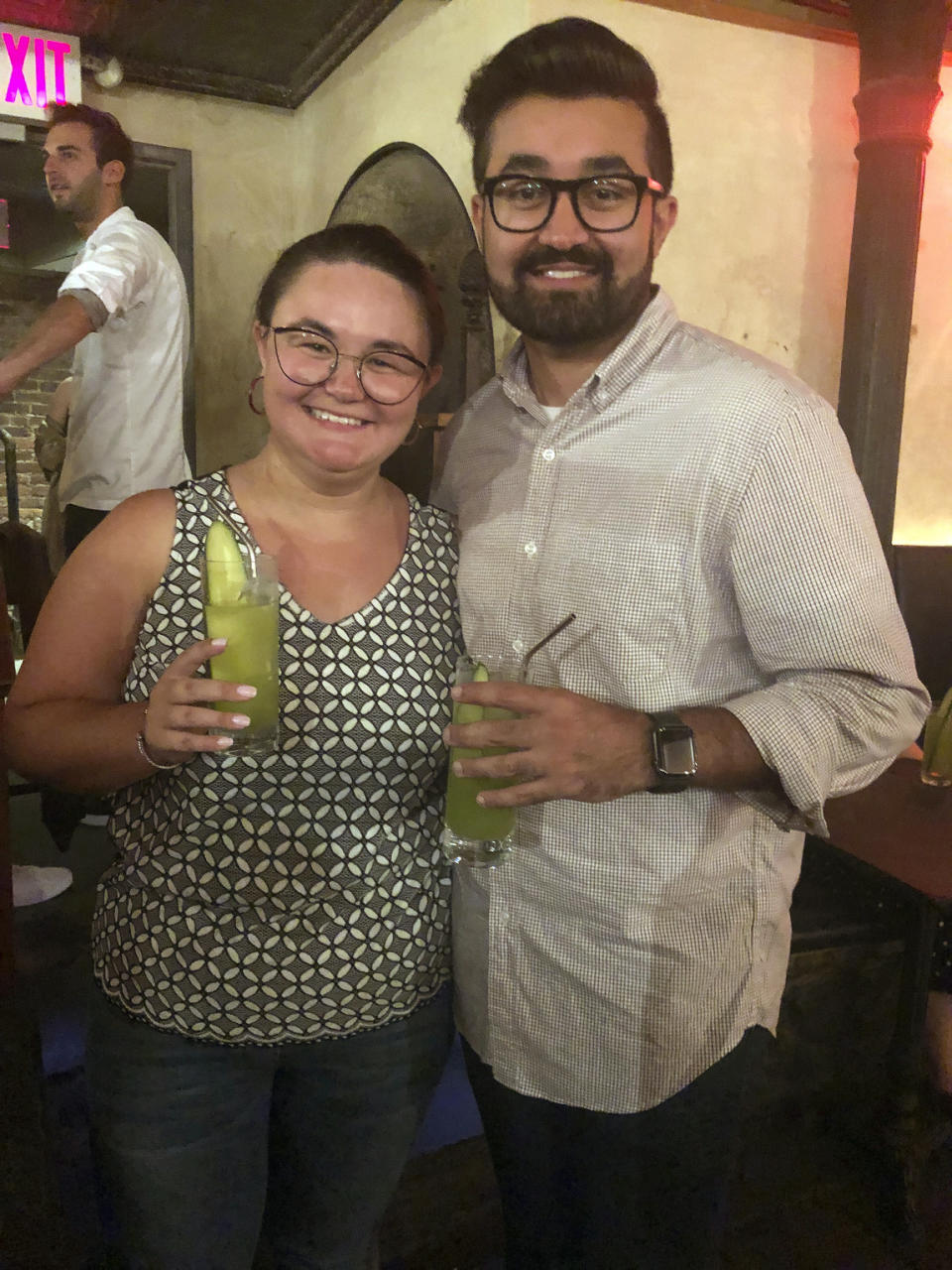 This Aug. 21, 2019 photo shows Cat Tjan, 27, of Jersey City, N.J., left, and Ammar Farooqi, 26, from Williamstown, N.J. posing their mocktail dubbed Me, A Houseplant, a green concoction comprised of Seedlip’s Garden 108 variety (the one with the peas), cucumber, lemon and elderflower at Listen Bar in New York. (AP Photo/Leanne Italie)