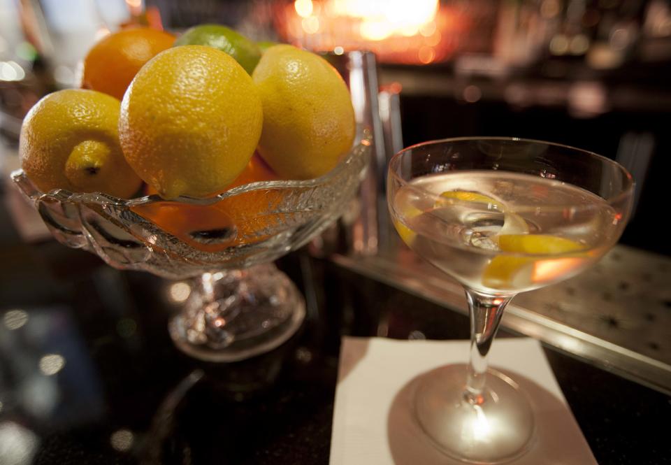 In this photo taken Thursday, Dec. 20, 2012, is a gin Martini cocktail near a bowl of fresh ingredients in the Starlight Room of the Sir Francis Drake Hotel in San Francisco. The first rule of drinking on a diet is, don't. Surely you saw the recent study that found that Americans were getting almost as many empty calories from alcohol as from soft drinks. The second rule of drinking on a diet is that since you probably will ignore Rule No. 1, find a way to enjoy alcohol without letting it swamp your healthy intentions. (AP Photo/Eric Risberg)