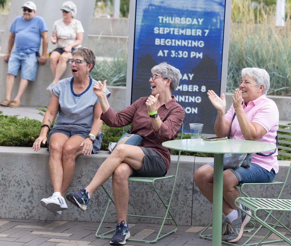 Friends, Polly Moss, left, Patty Lovell, middle, and Becky Risaliti, enjoy the music of Tom Lerch and Matt Dowdy at the Downtown Canton Music Fest.