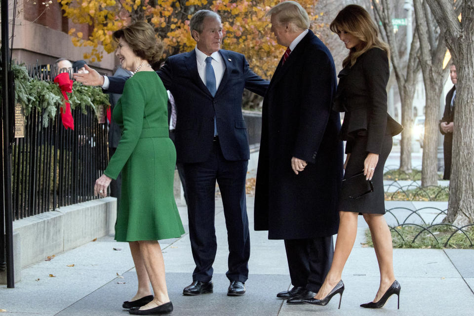 Former President George W. Bush and former first lady Laura Bush leads President Donald Trump and first lady Melania Trump into Blair House across the street from the White House in Washington, Tuesday, Dec. 4, 2018. (AP Photo/Andrew Harnik)