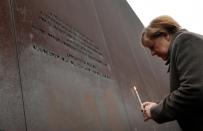 German Chancellor Angela Merkel said the fall of the Berlin Wall reminds "us that we have to do our part for freedom and democracy"