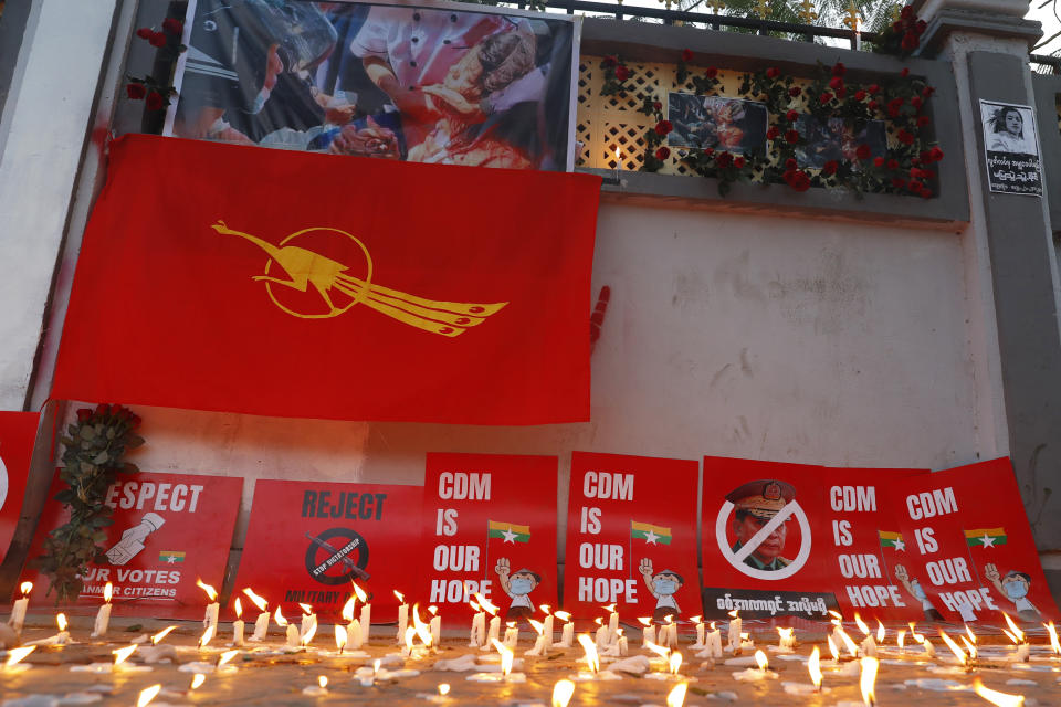 Candles remain lit in a makeshift memorial for Mya Thwet Thwet Khine in Mandalay, Myanmar Friday, Feb. 19, 2021. Mya Thwet Thwet Khine, the young woman who was shot in the head by police during a protest last week against the military's takeover of power in Myanmar died Friday morning, her family said. (AP Photo)