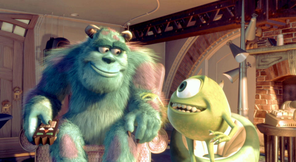 Sulley and Mike Wazowski smiling at each other while watching TV