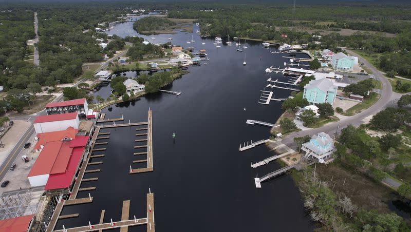 In this photo taken with a drone, storm clouds loom over riverfront homes and Sea Hag Marina, bottom left, in Steinhatchee, Fla., ahead of the expected arrival of Hurricane Idalia, Tuesday, Aug. 29, 2023.