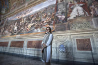 Vatican Museum director Barbara Jatta poses in the Costantino Hall, with frescoes by Italian Renaissance artist Raphael as the Vatican Museum reopened, in Rome, Monday, June 1, 2020. The Vatican Museums reopened Monday to visitors after three months of shutdown following COVID-19 containment measures. (AP Photo/Alessandra Tarantino)