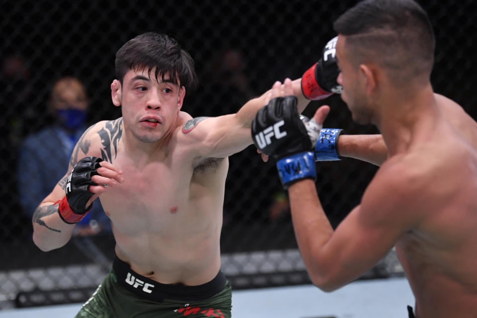 LAS VEGAS, NV – NOVEMBER 21: (L-R) Brandon Moreno of Mexico punches Brandon Royval in their flyweight bout during the UFC 255 event at UFC APEX on November 21, 2020 in Las Vegas, Nevada. (Photo by Jeff Bottari/Zuffa LLC via Getty Images)