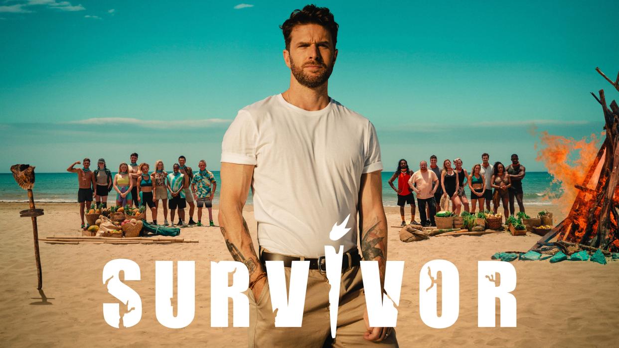  The key art for Survivor UK 2023 featuring Joel Dommett and the contestants on a beach. 