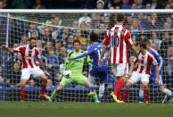 Chelsea's Mohamed Salah, center, scores against Stoke City during their English Premier League soccer match at Stamford Bridge, London, Saturday, April 5, 2014. (AP Photo/Sang Tan)
