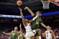 Arkansas forward Trey Wade (3) has his shot blocked by Charlotte defenders Aly Khalifa (15) and Jahmir Young (1) during the first half of an NCAA college basketball game Tuesday, Dec. 7, 2021, in Fayetteville, Ark. (AP Photo/Michael Woods)