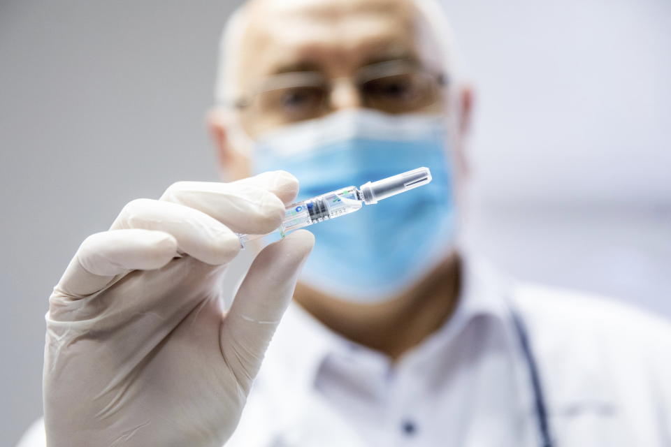 Csaba Lengyel, President of the University of Szeged's Szent-Gyorgyi Albert Clinic Center shows a vial of the vaccine against COVID-19 produced by Chinese Sinopharm at the university in Szeged, Hungary, Wednesday, February 24, 2021. (Tibor Rosta/MTI via AP)