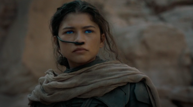 Still of Zendaya as Chani, she wears blue contacts and a black breathing apparatus called a stillsuit